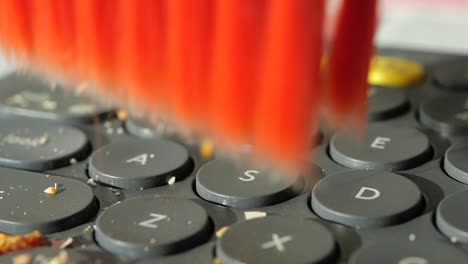 Cleaning a Keyboard with a Brush