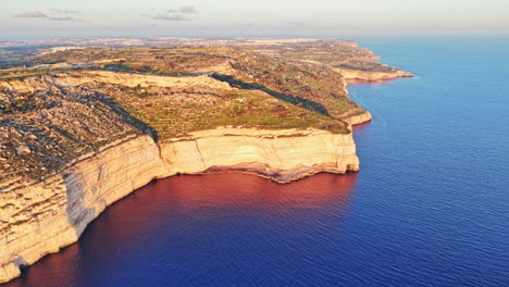 stunning aerial view of malta's coastal cliffs at sunset