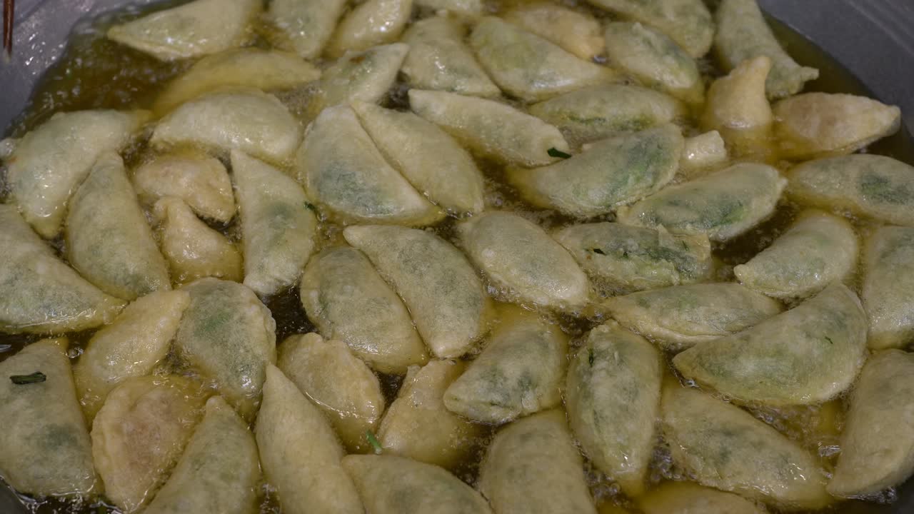 Close-up view of deep fried Dumpling on a wok pan