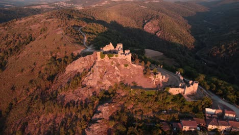 aerial-view-of-Couzan-Castle-at-sunrise,-french-fortress-in-Loire-Departement,-Loire-Forez,-Rhone-Alpes,-french-countryside