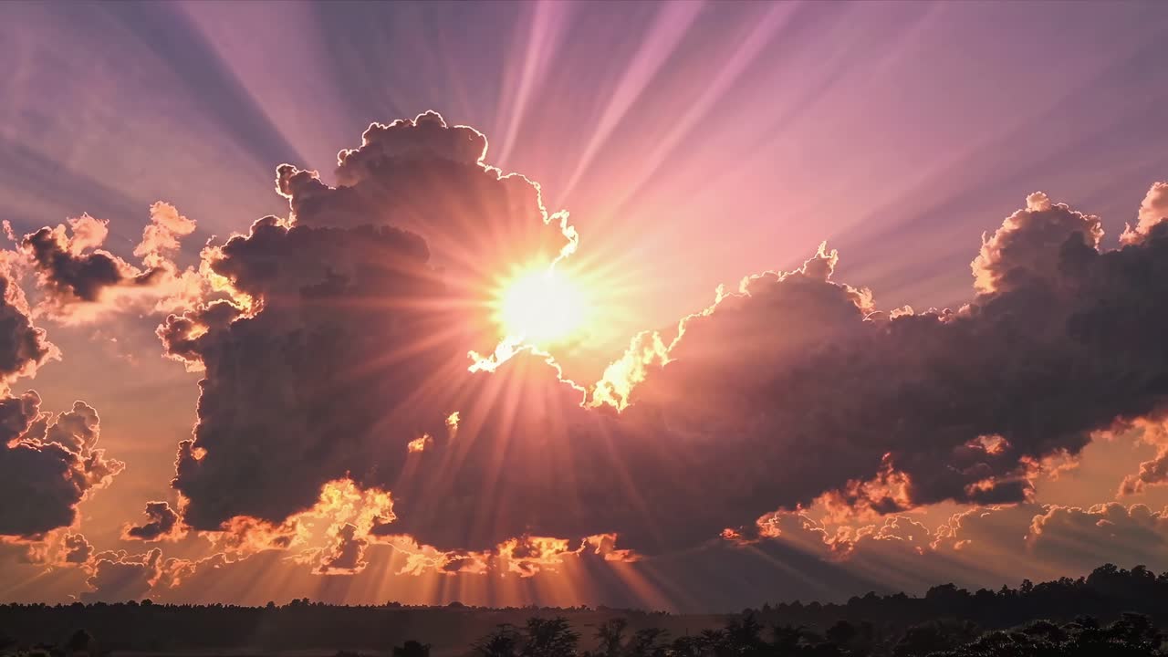 Dramatic sunset video with sun rays piercing through clouds, captured from a low angle