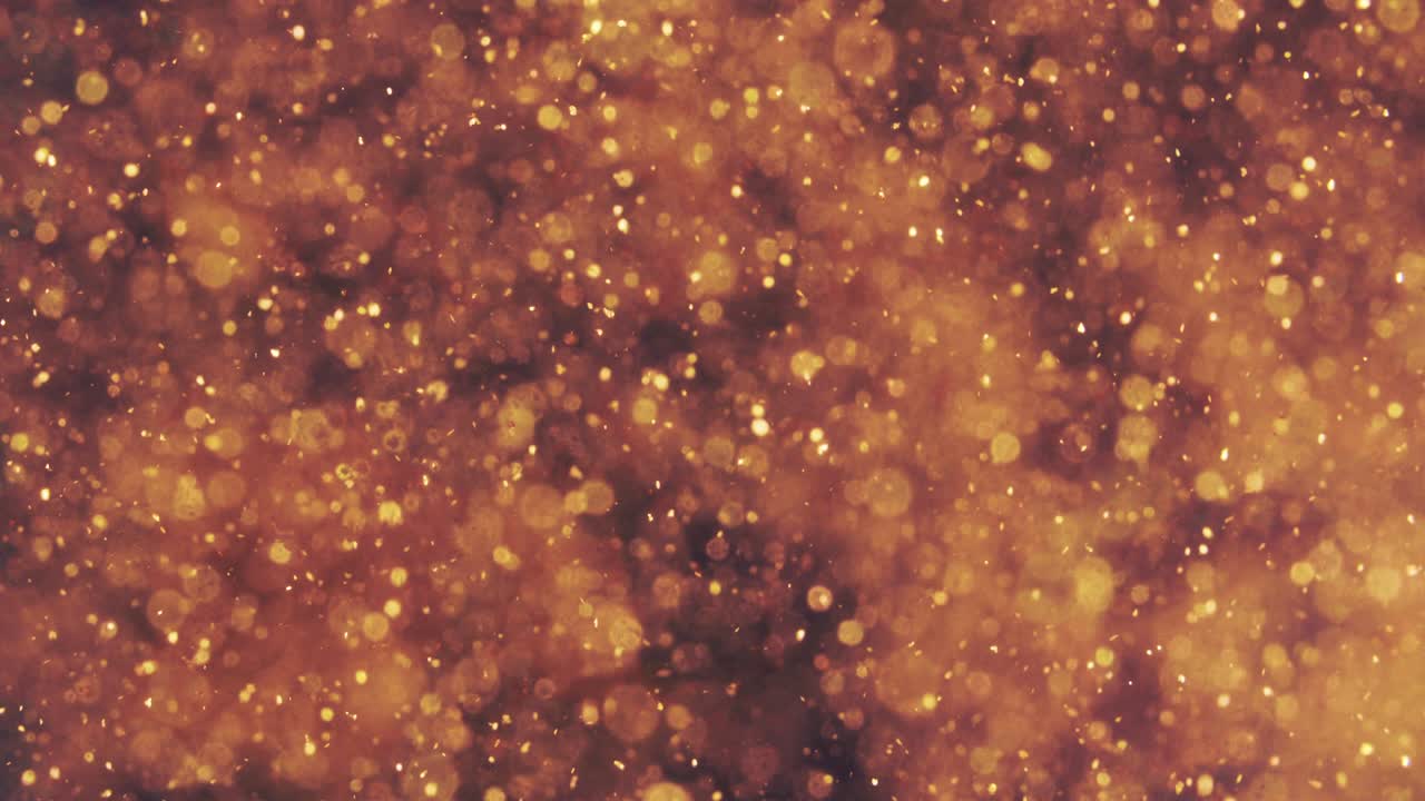 partículas doradas abstractas con borroso desfocado bokeh se mueve caos, copos de nieve