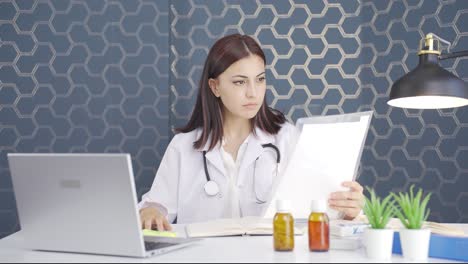 the woman doctor examining the paperwork is thoughtful.