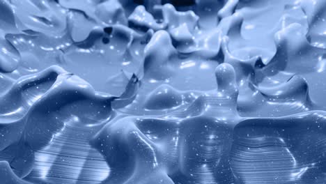 smooth animation of liquid black gradient in 4k. glossy paint surface as abstract looped stylish background. glitters in viscous liquid with 3d splashes on surface like drops. monochrome