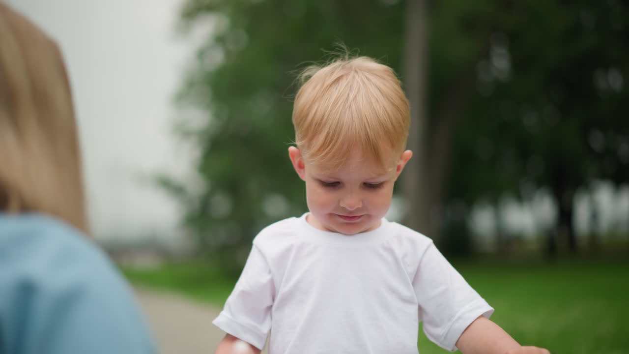 A close-up of a tender moment as a little boy receives a high five from a woman with beautifully painted nails