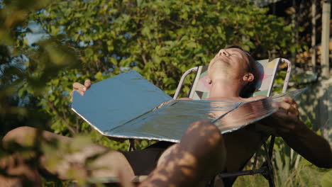 man sunbathing with a solar reflector
