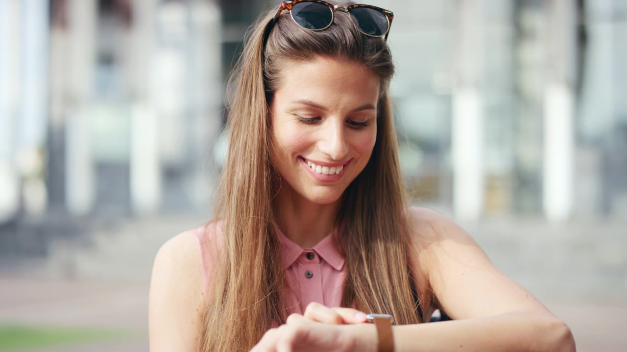 Young Woman Checking Her Smartwatch Outdoors
