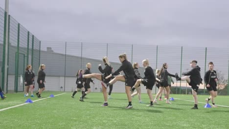 female soccer teammates training drills, stretch exercises, slow-mo