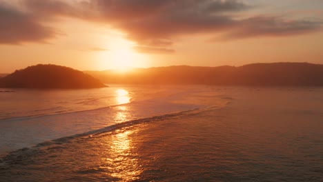 sunrise at the surf spots of gerupuk in lombok, with a view on the bay with the fishing boats and surfers