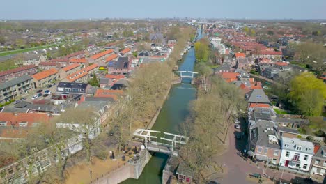 Reversing-aerial-reveal-over-canal-in-Vreeswijk,-Utrecht