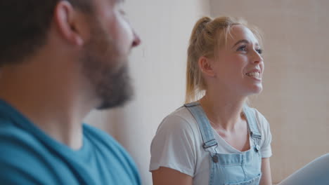 Close-Up-Of-Couple-Decorating-Room-At-Home-Sitting-On-Floor-Taking-A-Break-With-Hot-Drink