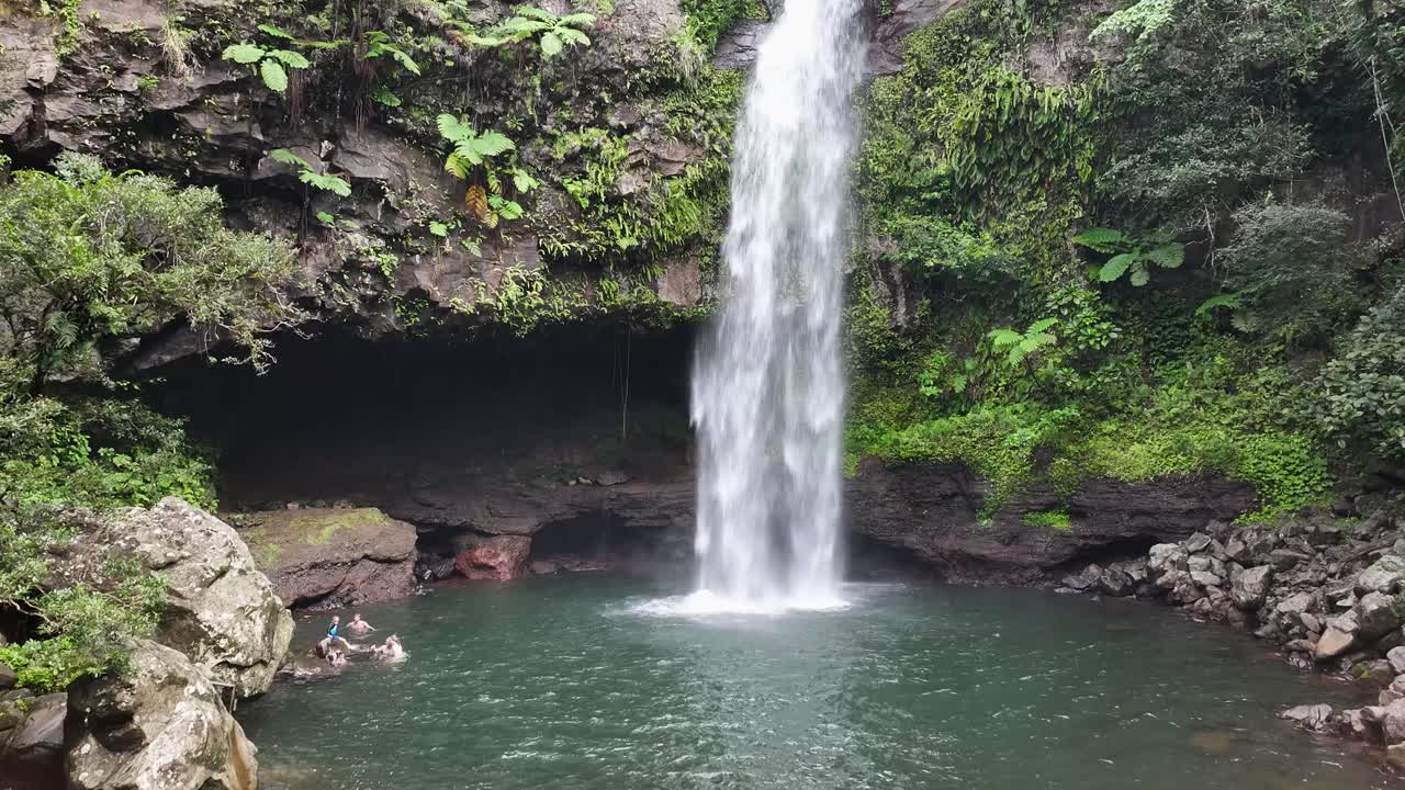 Tavoro Waterfalls, Bouma, Fiji. Pristine natural falls in jungle, Taveuni Island. Aerial crane, people swim