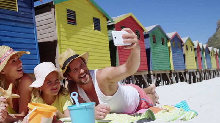 famiglia che si fa un selfie con il telefono cellulare in spiaggia
