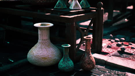 a collection of decorative pottery vases on a wooden table