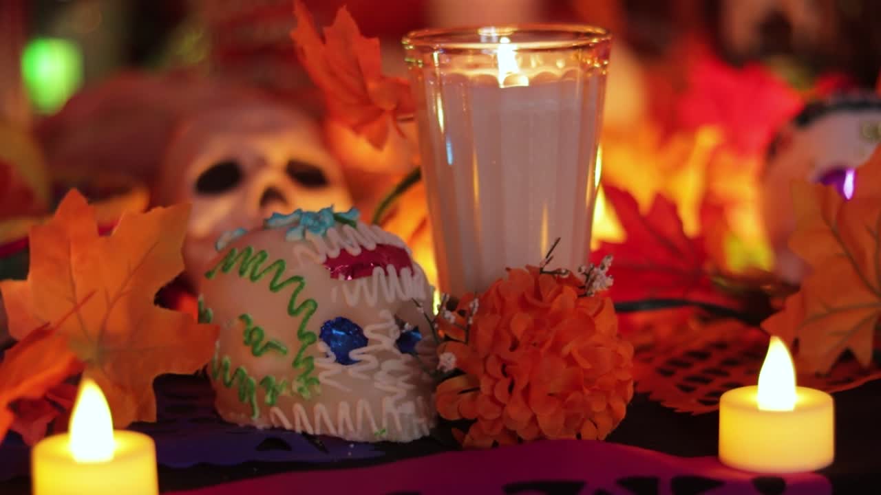 Día de Muertos festival altar skull decorations and burning candles