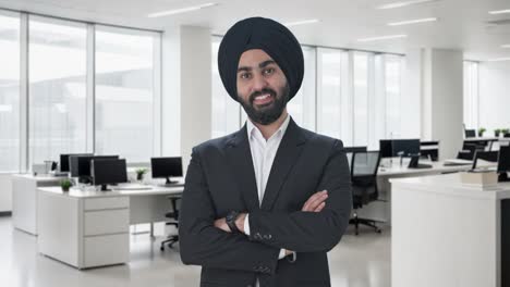 happy sikh indian businessman standing crossed hands