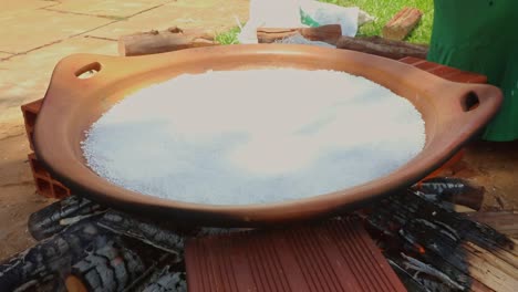Frying-beiju-or-a-large-tapioca-crepe-in-a-large-flat-clay-pot---indigenous-traditional,-tribal-recipe-from-the-Amazon-rainforest