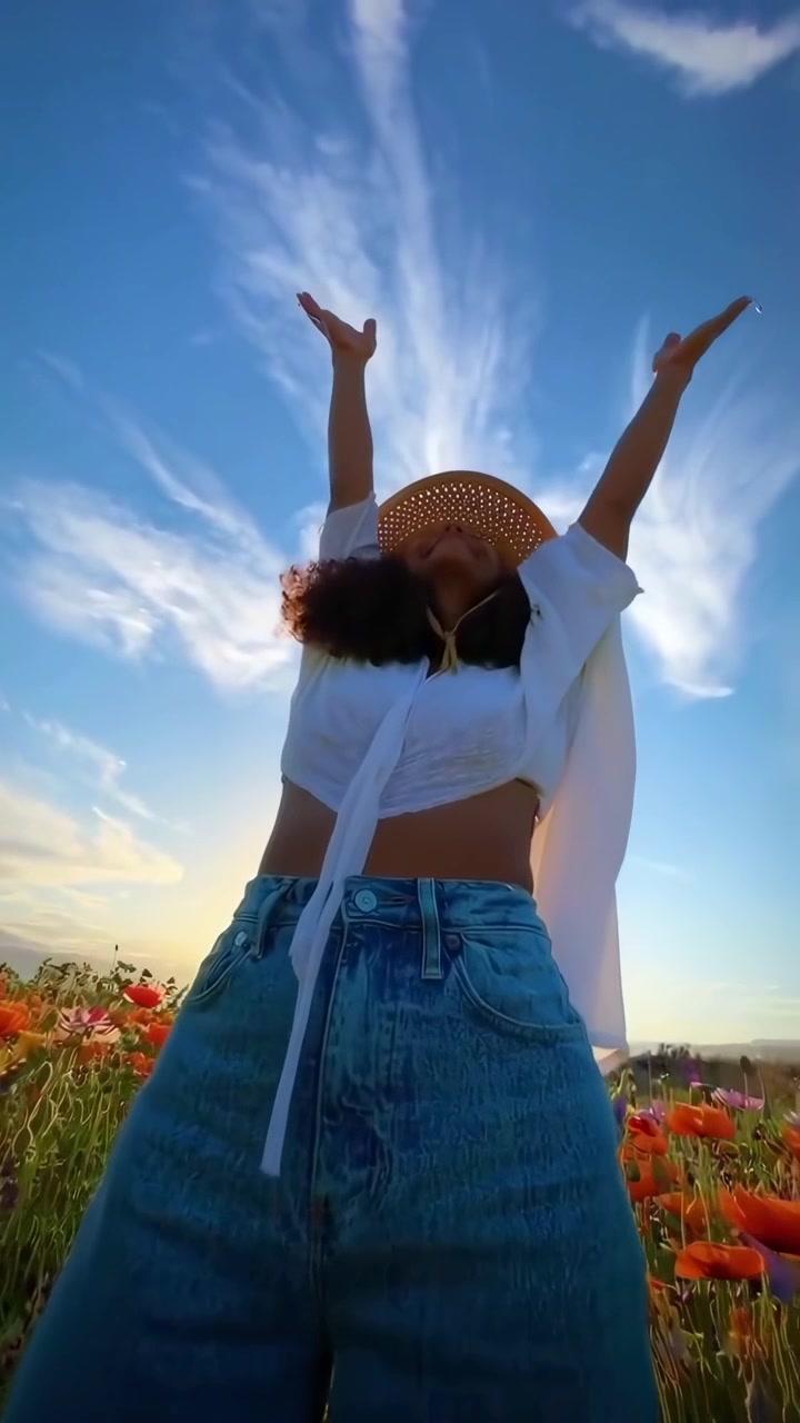 Mujer feliz disfrutando de la naturaleza en un campo de amapolas de colores