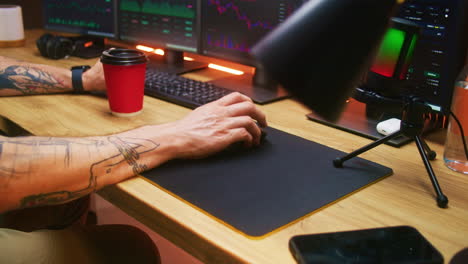 Male-Trader-Uses-Computer-Mouse-Types-on-Keyboard-Analyzes-Realtime-Stocks