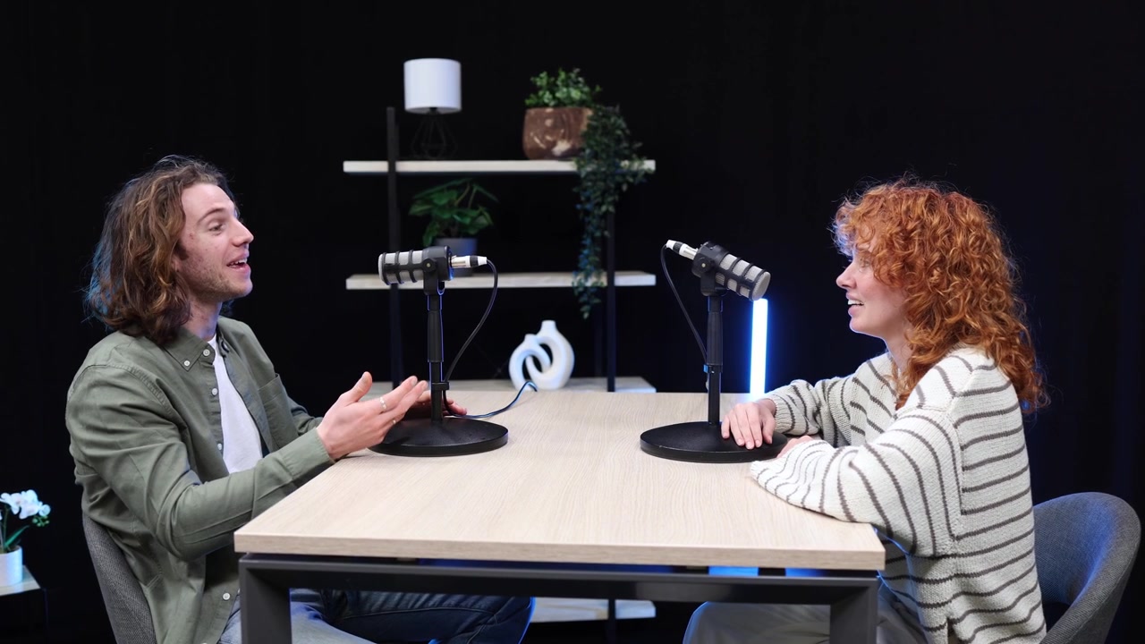 Young Man and Woman Recording a Podcast in a Modern Studio