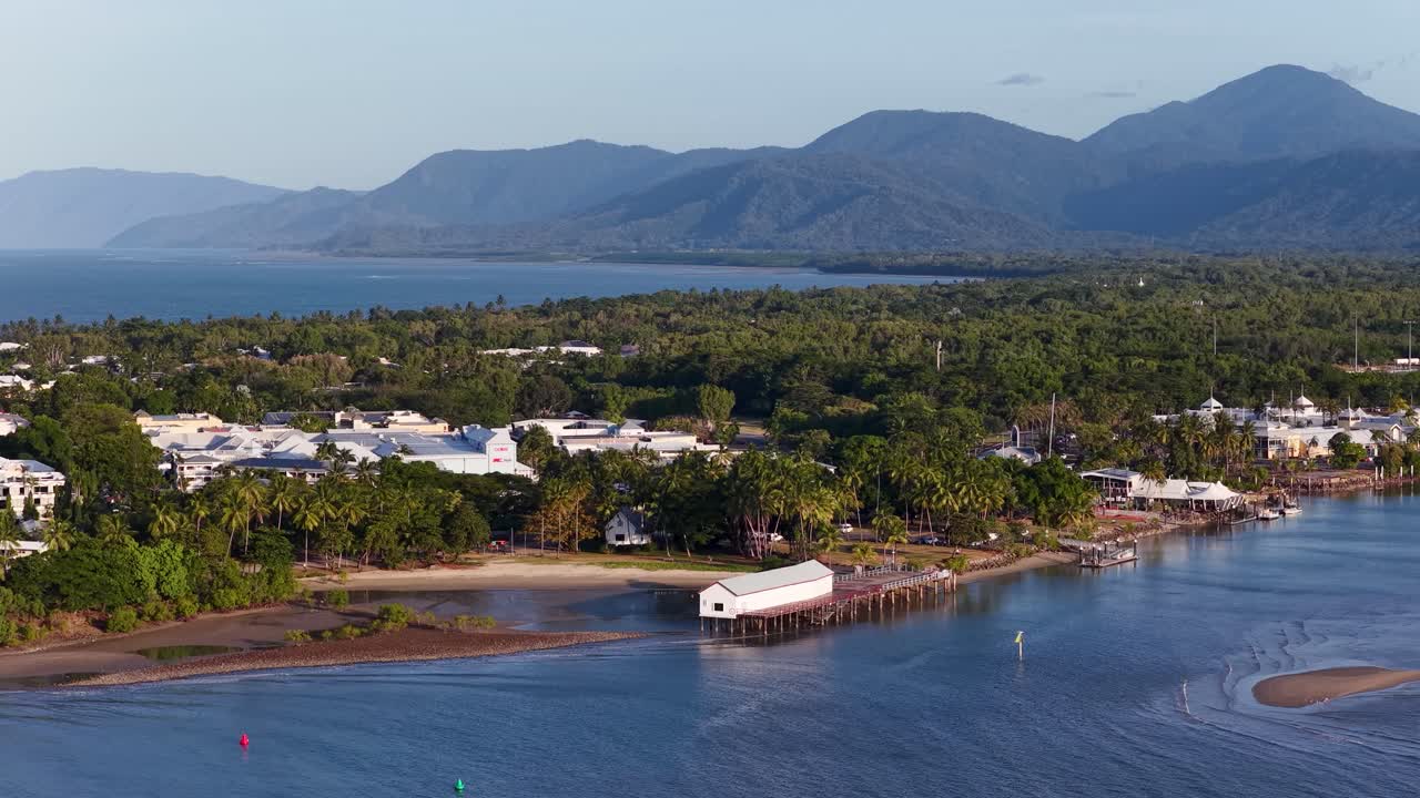 Drone footage showcasing coastal town and mountains