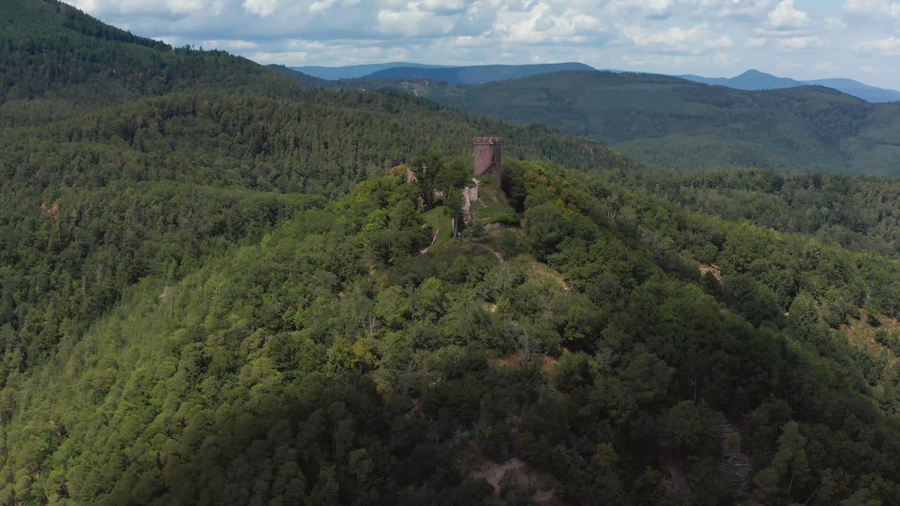 Approaching aerial shot of a medieval castle in the Alsace region of France.