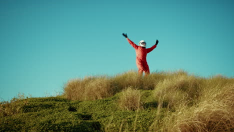 astronaut looks out from the mountain and asks for help gesturing for rescue