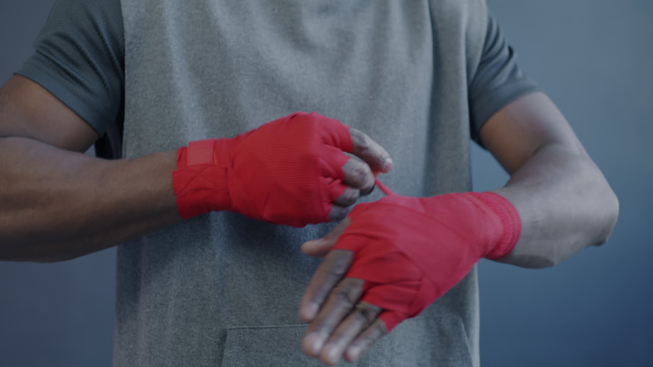Man Putting on Boxing Wraps