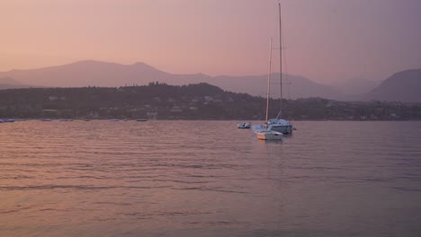 Beautiful-Evening-Scene-From-Lake-Garda-in-Northern-Italy-Sailboats-Swinging-at-Ancor