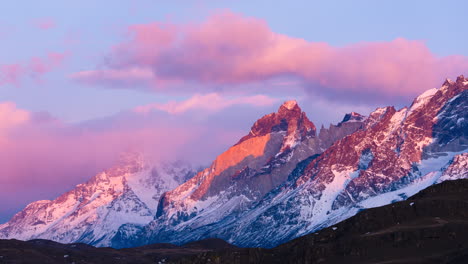 Timelapse-View-Of-The-Sunrise-and-Clouds-Forming-Around-Snowcapped-Torres-del-Paine-Mountains