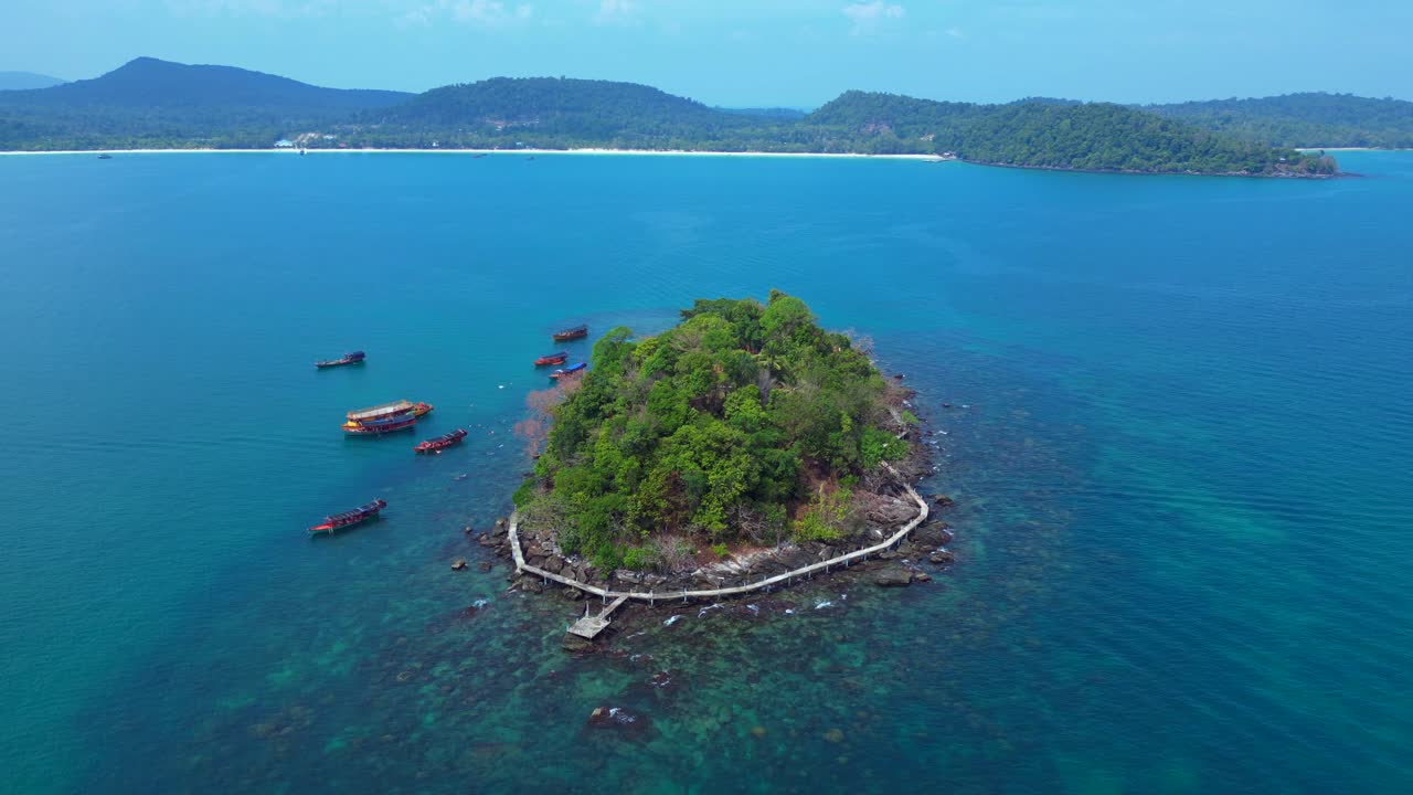 Tourist boats surrounding tropical Koh Toch Island near Sihanoukville, Cambodia. Dramatic aerial view flight panorama overview drone