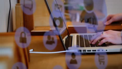 animation of technology icons over hands of caucasian woman working on laptop