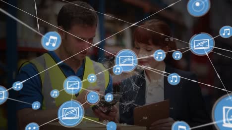 Animation-of-network-of-connections-with-icons-over-diverse-workers-in-warehouse