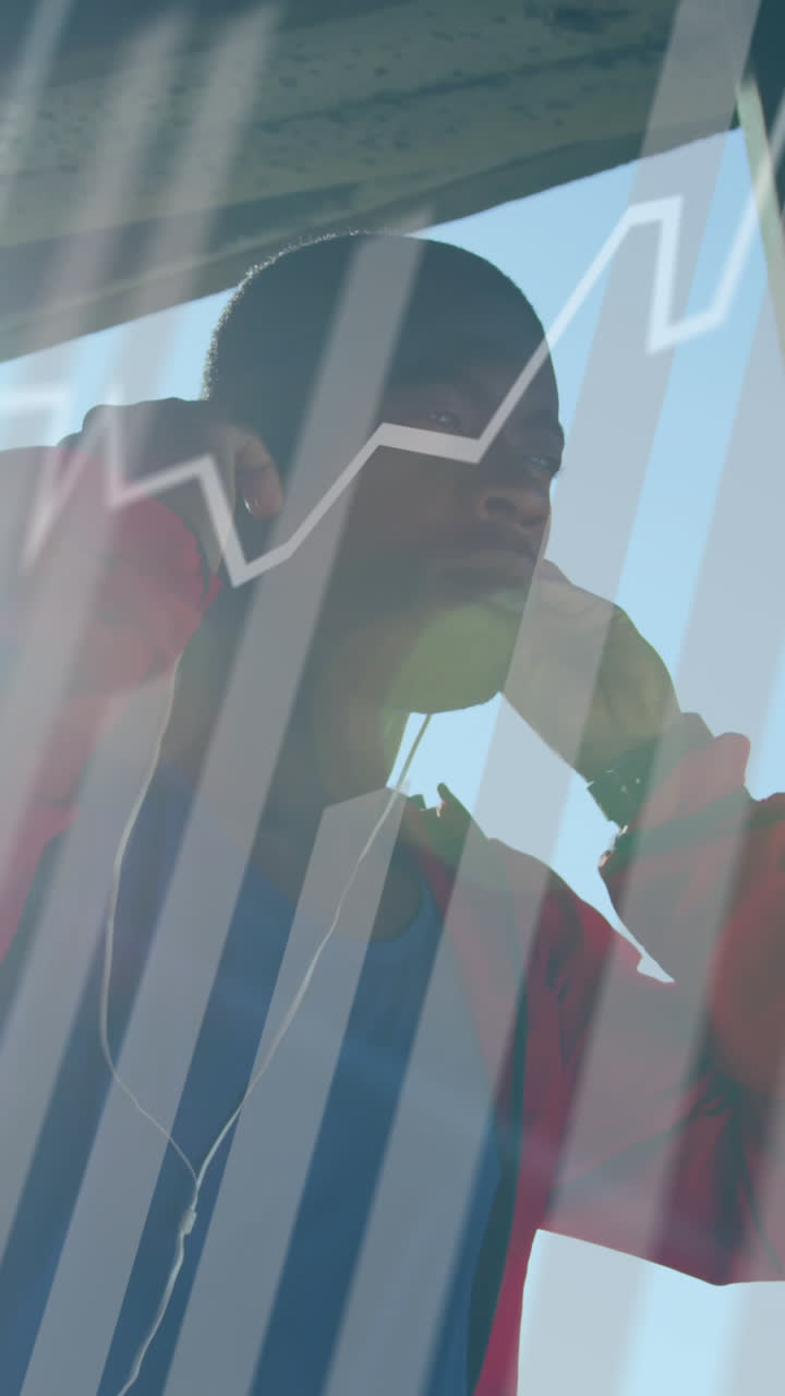 Elaborazione di dati statistici sullo sfondo di un uomo afroamericano in forma con auricolari all'aperto.