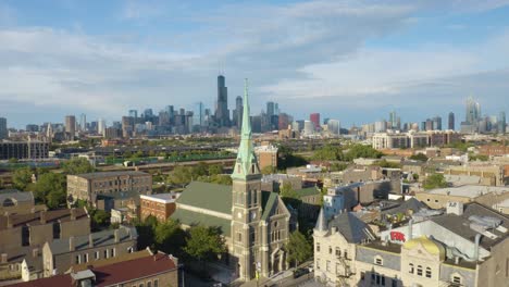 cinematic drone shot above pilsen neighborhood looking downtown chicago skyline on beautiful summer afternoon