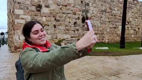 A woman is taking a picture of herself with her cell phone