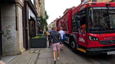 pedestrians and vehicles on a bustling street