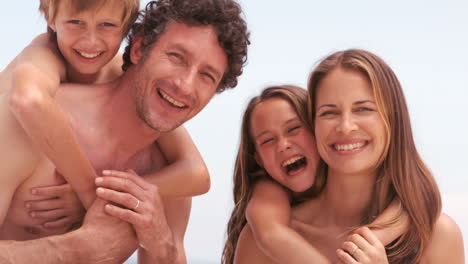 Smiling-family-looking-at-camera