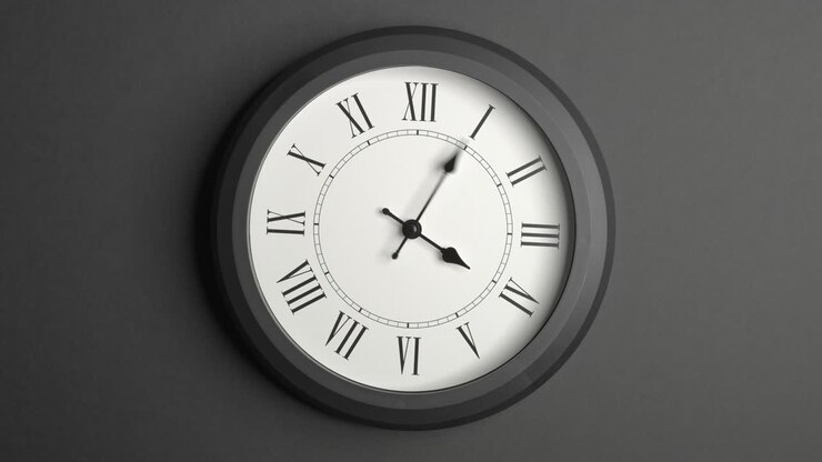 Latin Clock Face in Time Lapse on Dark Grey Wall