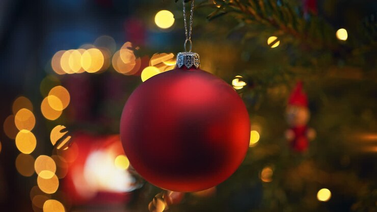 Christmas Tree Decorated With Red Glass Bauble And Fairy Lights By The Fireplace - Slow Motion