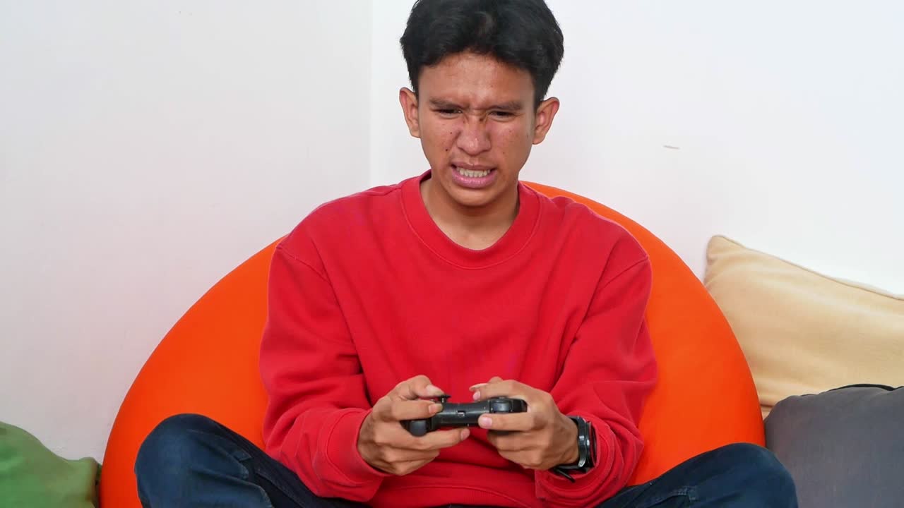 Young man intensely playing video games engrossed and focused on virtual challenges for ultimate fun
