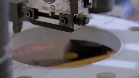 Milling machine cutting metal workpiece at technology exhibition - close up