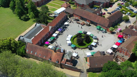 aerial flying over ashford hangers market sunny day uk 4k