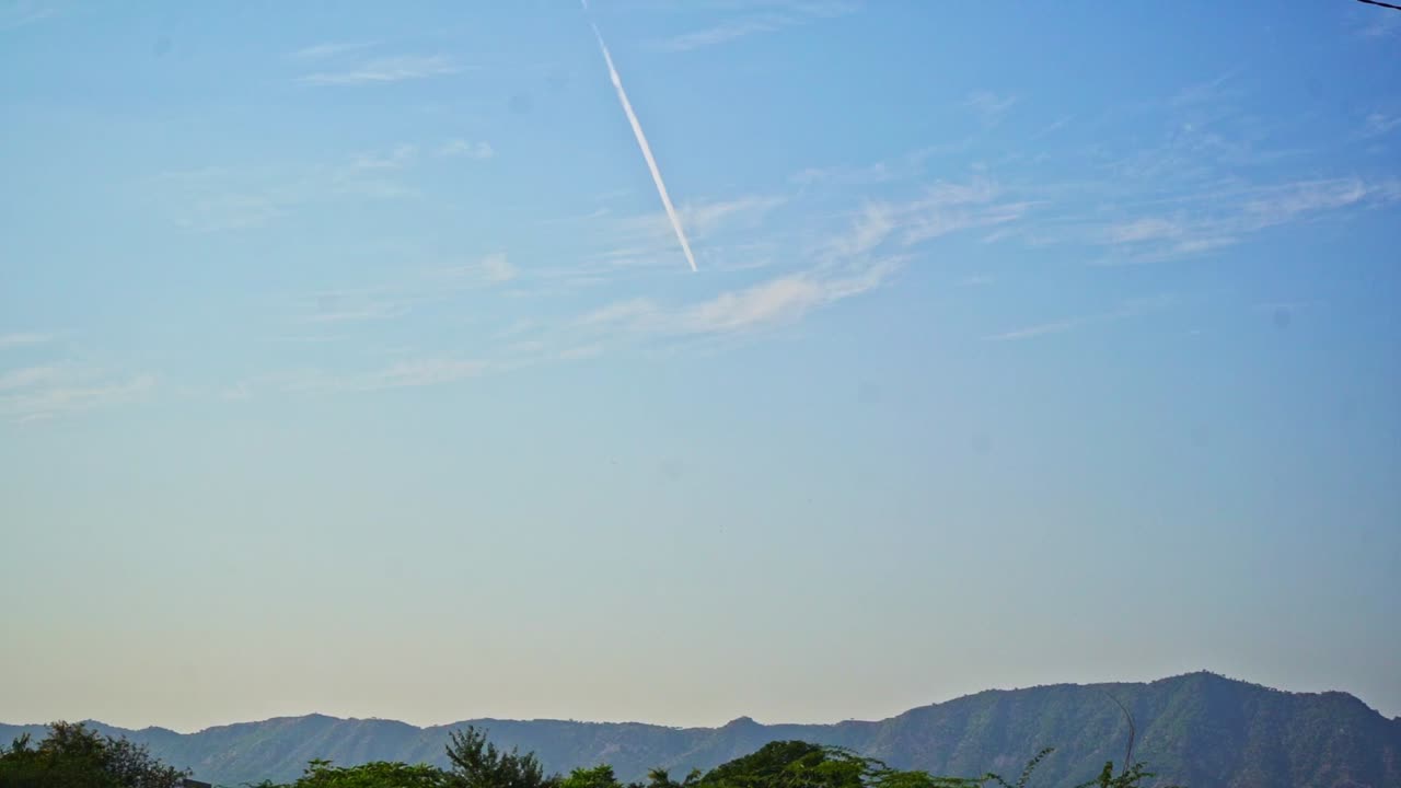Beautiful shot of a plane leaving behind contrails