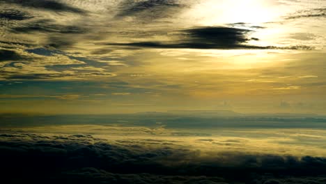 time lapse of sunrise or sunset, above the clouds,clouds billowing.