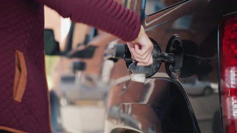 Woman-Pumps-Gas-in-Black-Car