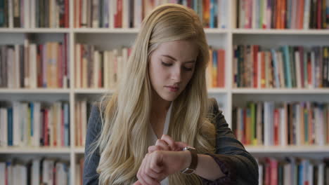 portrait-beautiful-blonde-business-woman-using-smart-watch-browsing-online-checking-messages-on-mobile-device-slow-motion