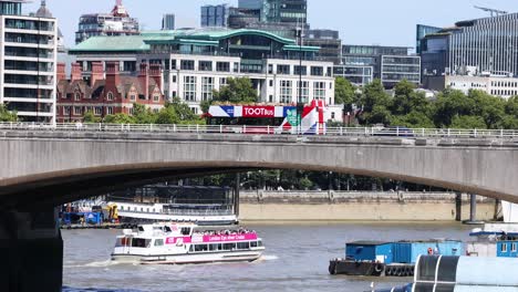 a boat travels under a bridge in london