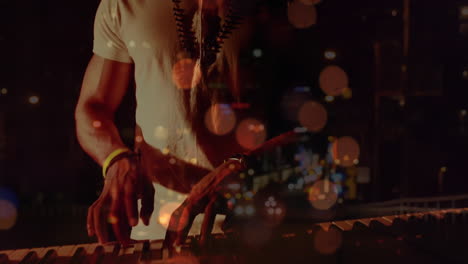 animation on blurred night road traffic over caucasian man playing keyboard on concert