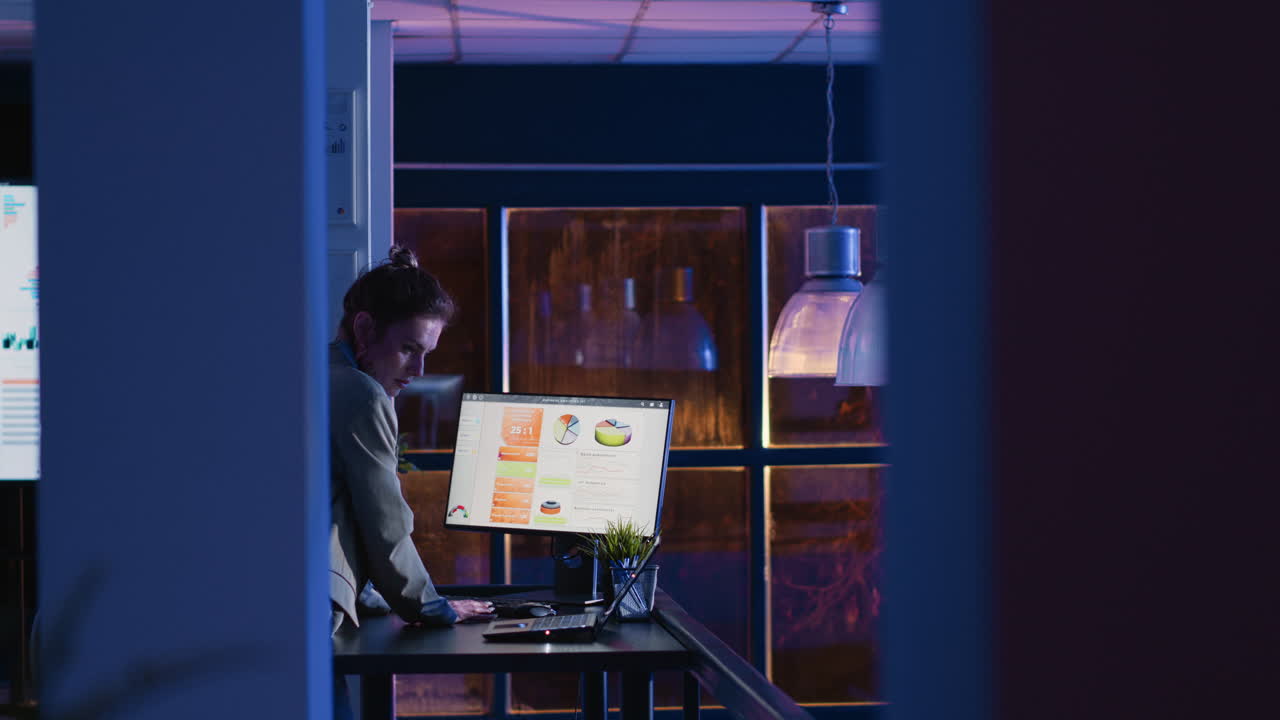 Businesswoman working on computer with analytics in office